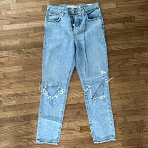 Light wash blue jeans with ripped knees